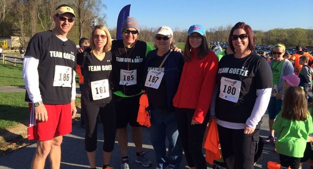 Group photo of team Give & Goetze posing before Roar for Autism 5k.