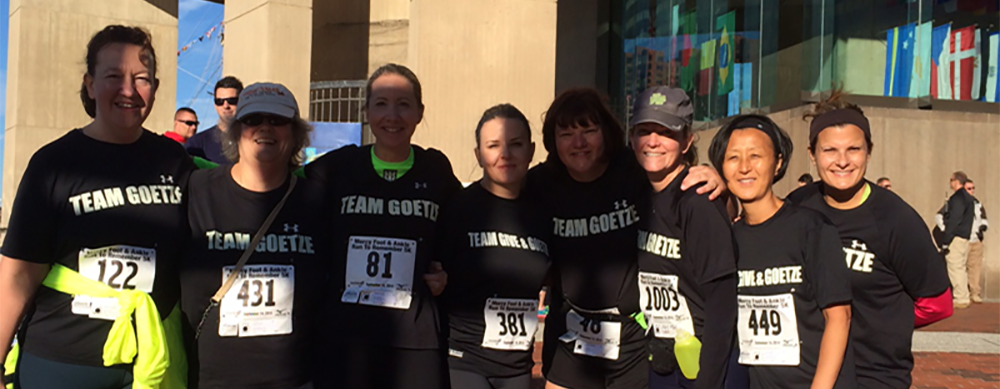 Group photo of team Give & Goetze posing after completing the Run to Remember 5K in downtown Baltimore.