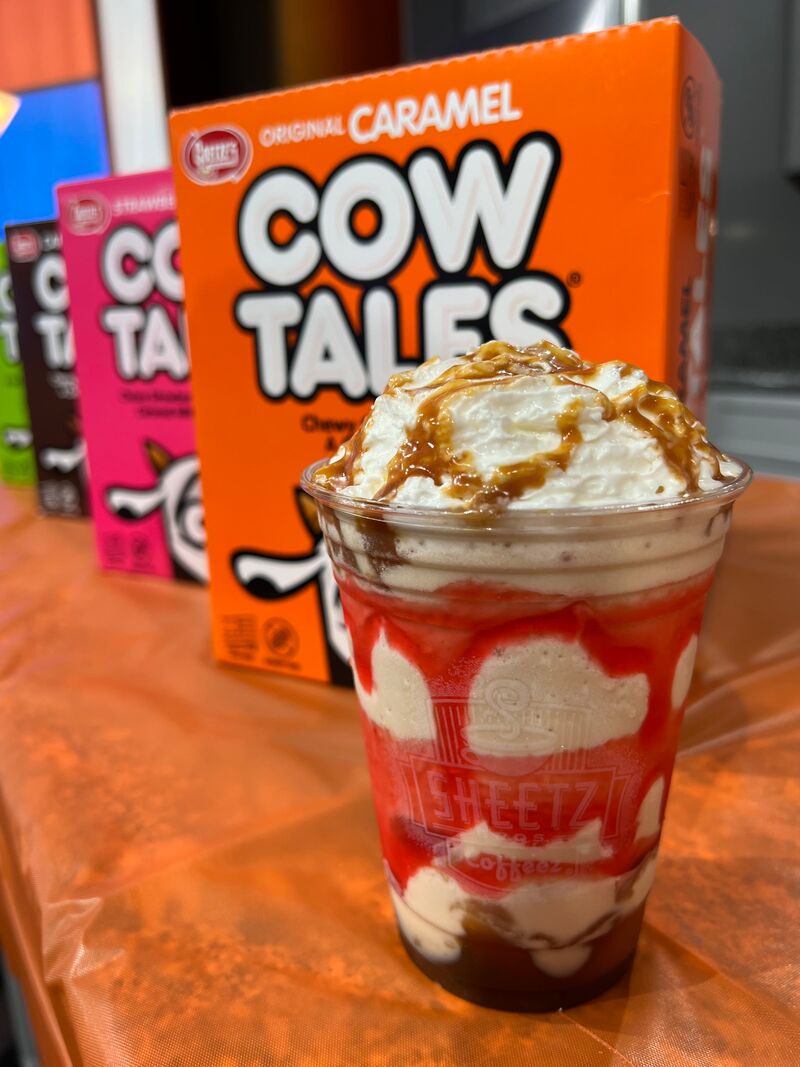 Caramel Cow Tales milkshake with whipped cream, drizzled with caramel and apple syrup on top and throughout the shake.