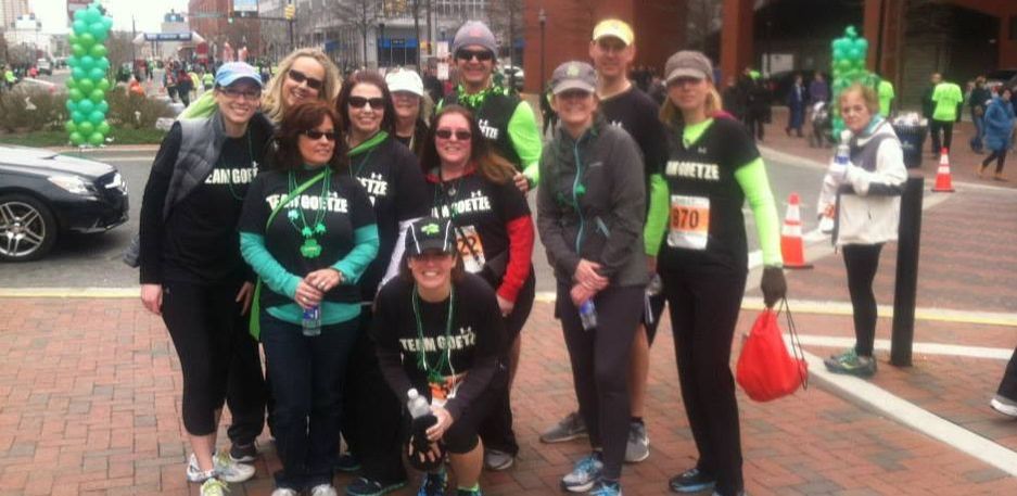 Team Give & Goetze posing after the Kelley’s St. Patrick’s Day Shamrock 5K.