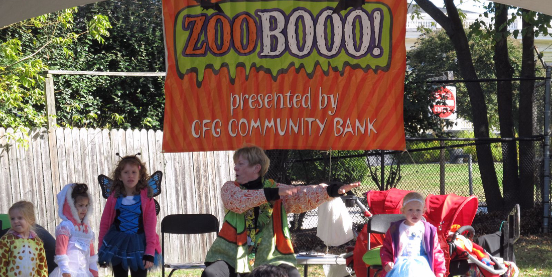 Children in Halloween costumes stand on stage at ZOOBOOO!, a family event sponsored by CFG Community Bank.