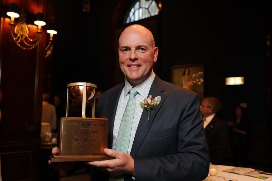 Mitchell Goetze smiling with his Kettle Award