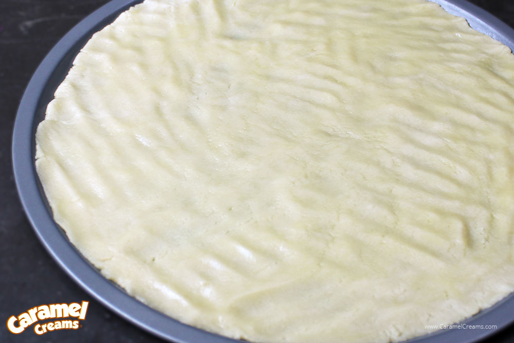 Cookie dough crust prepped for the oven