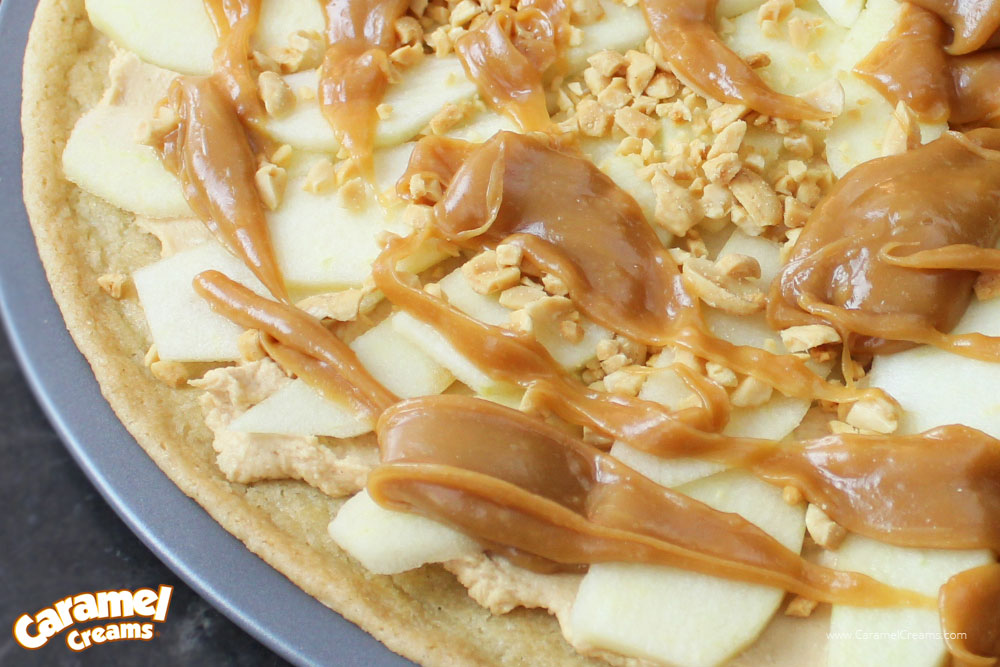 Crisp Apple Dessert Pizza with caramel sauce drizzled on top