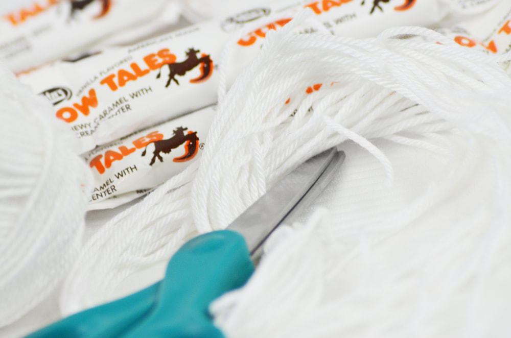 Cow Tales, string, and scissors