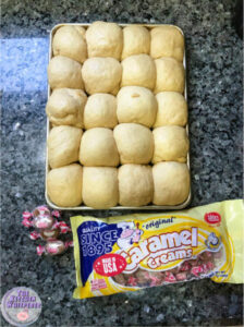 Rolls on baking dish with a bag of caramel creams