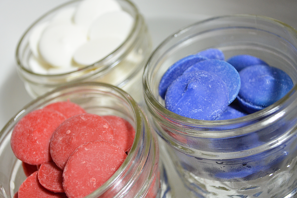 Red, white, and blue melts seperated into 3 mason jars