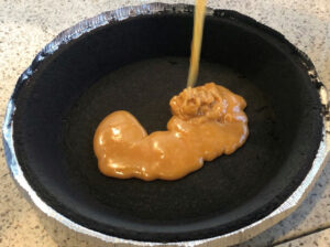 Melted caramel poured into a chocolate pie crust