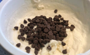 Whipped cream in a bowl with chocolate chips