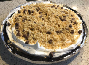 Turtle Ice Cream Pie topped with walnuts and chocolate chips